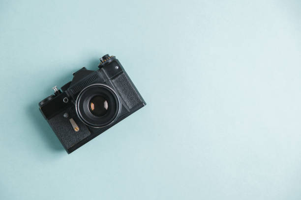 istock Retro camera on bright background. Minimalistic layout of the photographer. 1194498662
