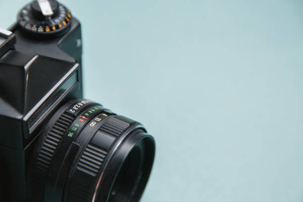istock Retro camera on bright background. Minimalistic layout of the photographer. 1194498680