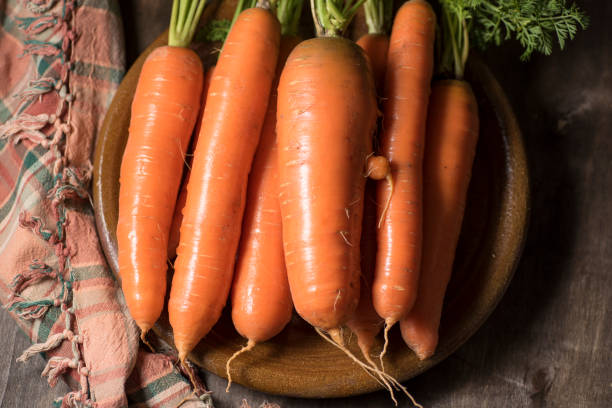 istock natural carrot on clay plate 1194498750