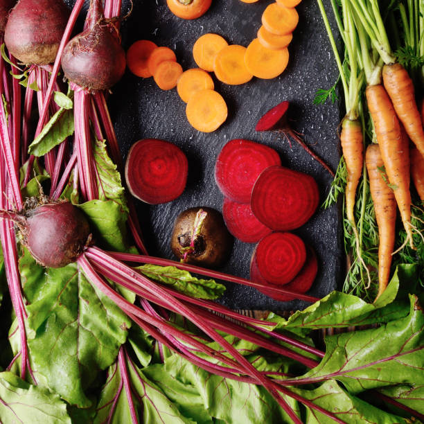 istock Top view at vegetable background of beets and carrots on kitchen table close up view 1194498813