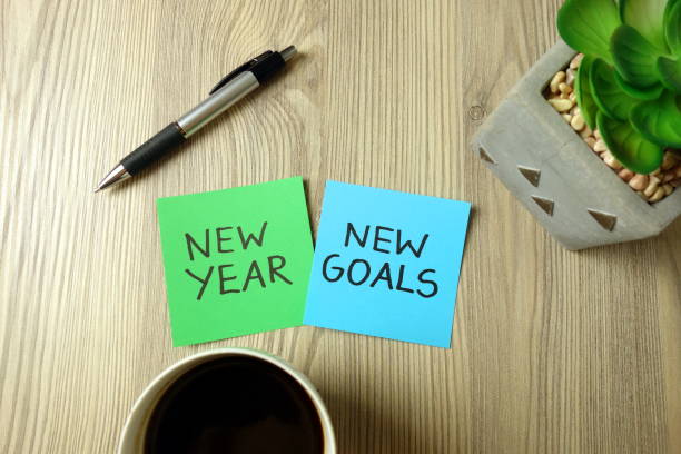 New Year goals concept New Year goals concept with text handwritten on sticky notes in office achievement aiming aspirations attitude stock pictures, royalty-free photos & images