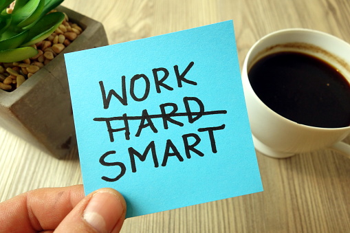 Work smart text - motivational reminder handwritten on sticky note