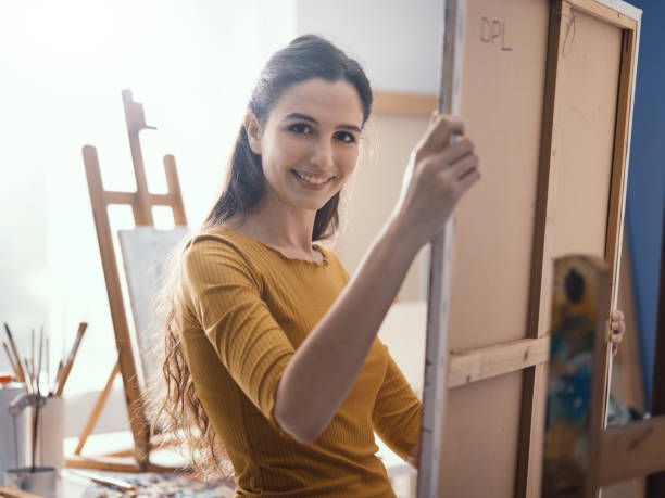 istock Young artist putting a canvas on the easel 1194499848