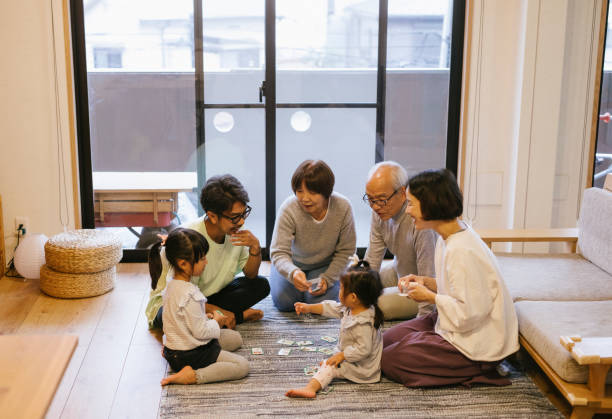 Family playing cards Family playing karuta cards on New Year's day family playing card game stock pictures, royalty-free photos & images