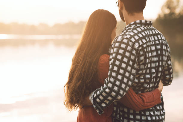 istock Loving couple hugging at the lake 1194502322