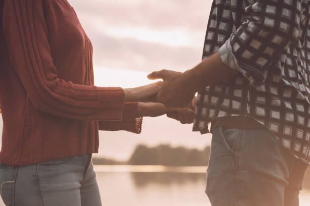 istock Romantic loving couple holding hands 1194502608