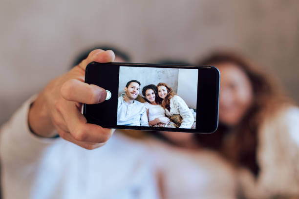 istock Family taking a selfie while enjoying on the sofa 1194505363