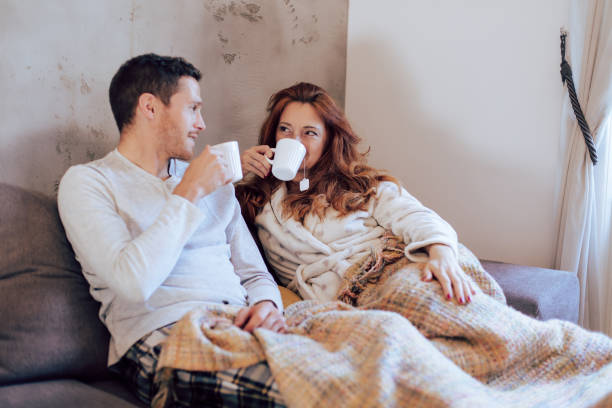 istock Husband and wife relaxing on the couch 1194505364