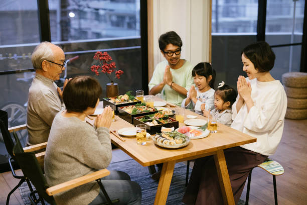 Family gathering on New Year's Day Japanese two generation Family sitting together behind the table on New Year's Eve. baby new years eve new years day new year stock pictures, royalty-free photos & images