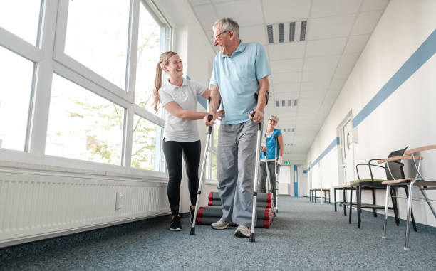 istock Seniors in rehabilitation learning how to walk with crutches 1194508712
