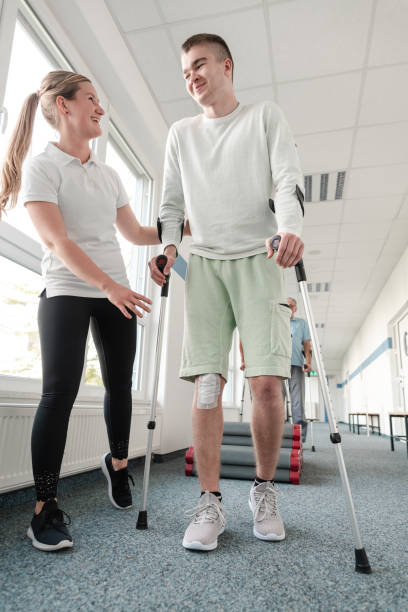istock People in rehabilitation learning how to walk with crutches 1194508808