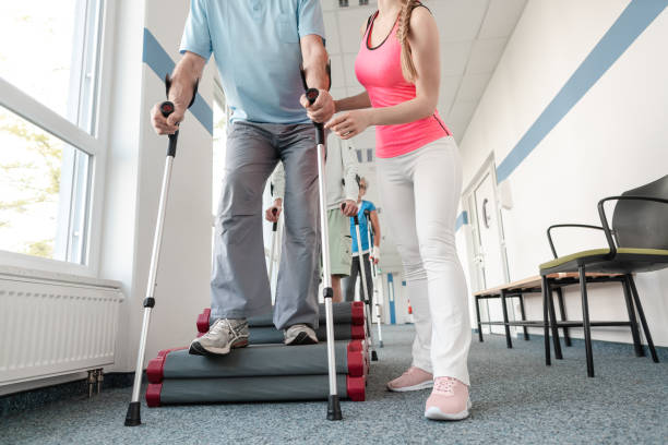 istock Seniors in rehabilitation learning how to walk with crutches 1194509035