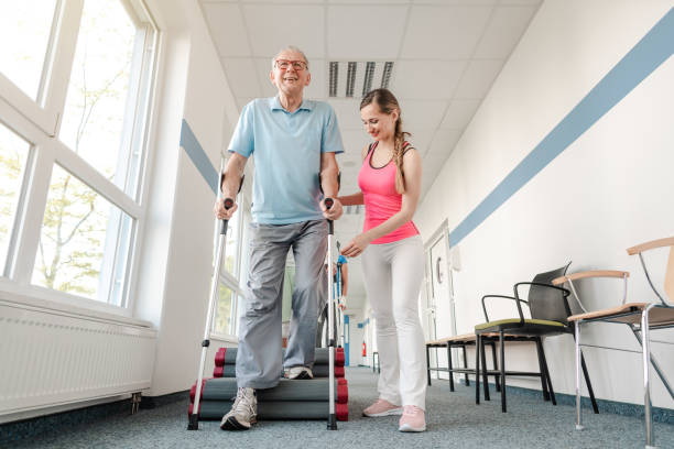 istock Seniors in rehabilitation learning how to walk with crutches 1194509057