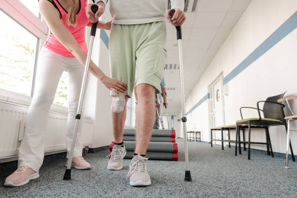 istock People in rehabilitation learning how to walk with crutches 1194509107