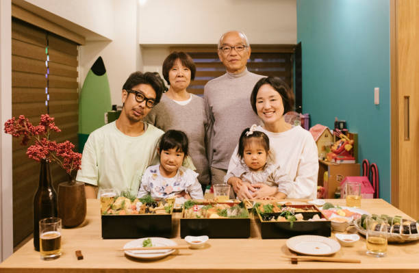Portrait of a Three generation Family behind a dinner table.