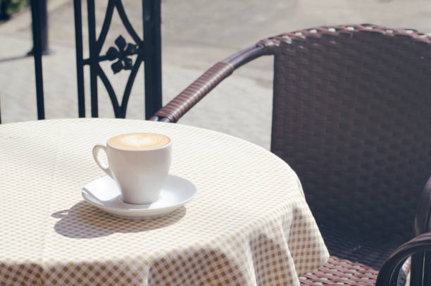 istock A cup of cappuccino on a table with a checkered tablecloth. 1194511497