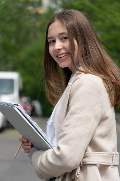istock Young female student posing outdoors 1194511777