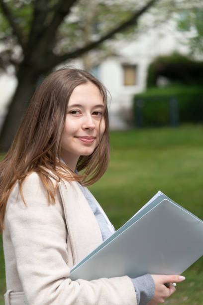 istock Young female student posing outdoors 1194511782