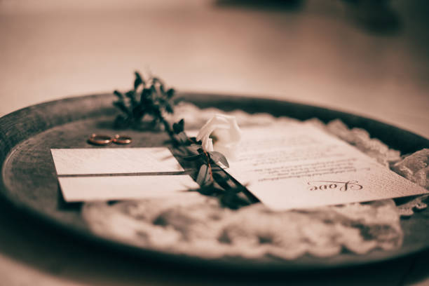 istock close up.wedding invitations and wedding rings on a silver tray 1194512615