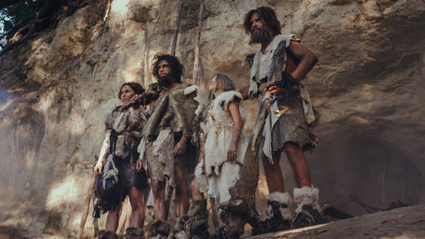 Tribe Of Huntergatherers Wearing Animal Skin Holding Stone Tipped Tools  Stand Near Cave Entrance Neanderthal Family Ready For Hunting In The Jungle  Or Migration Stock Photo - Download Image Now - iStock