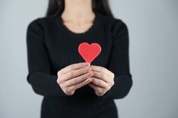 istock woman hand holding red heart 1194513900