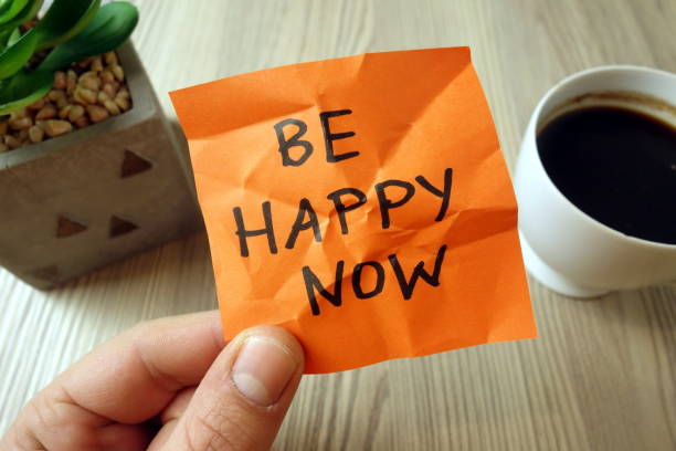 istock Be happy now - motivational reminder handwritten on sticky note 1194514608