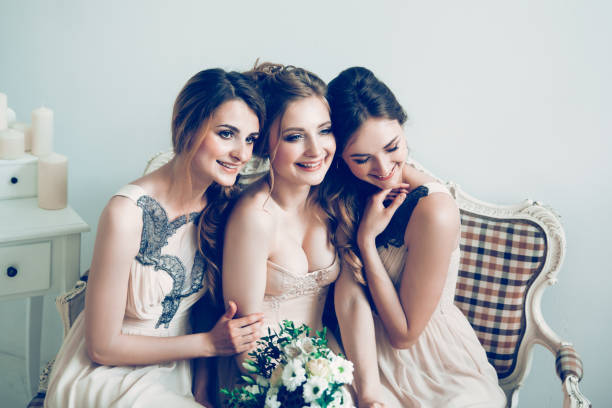 istock happy bride with her two friends sitting on the couch . 1194515365