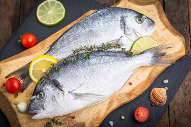 istock Fresh raw dorado fishon the wooden table 1194516134