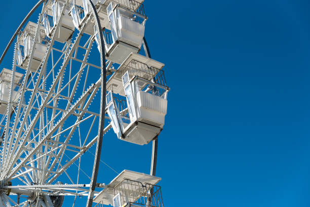istock White Ferris wheel in Hastings on blue background. 1194516929