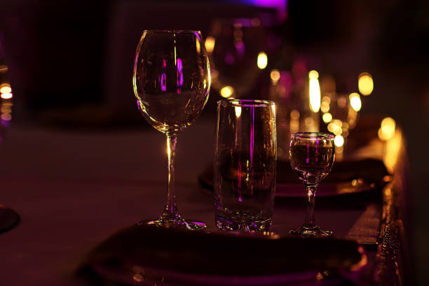 istock wine glasses on table on dark background. Wine glasses and grapes on stone table 1194518072