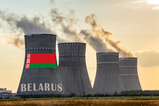 istock Nuclear plant chimneys displaying flag of Belarus with according text. Energy pollution accidents in a country concept. 1194518280