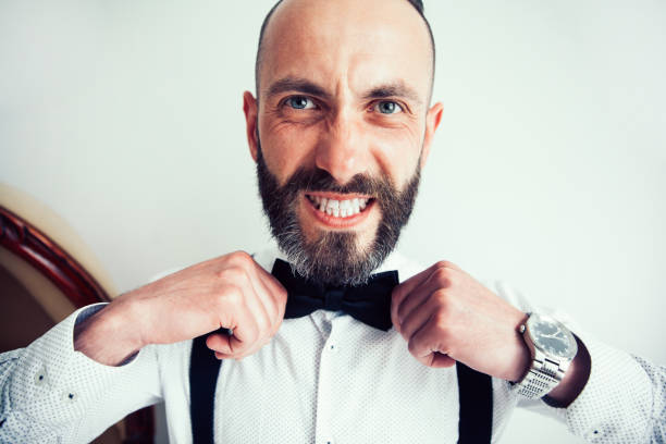 istock close up. man straightening his bow tie 1194518811