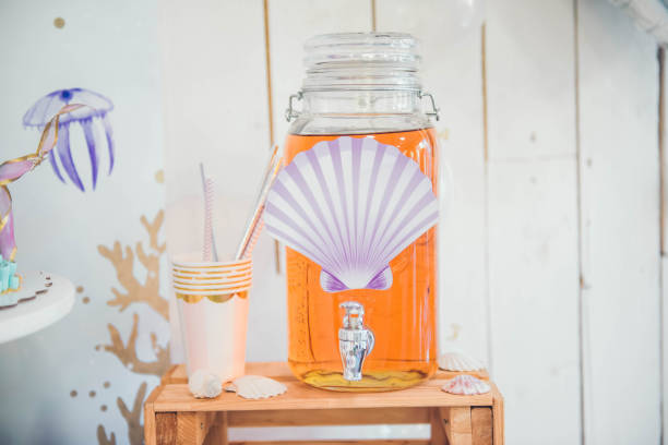 Lemonade in glass jar with tap stock photo