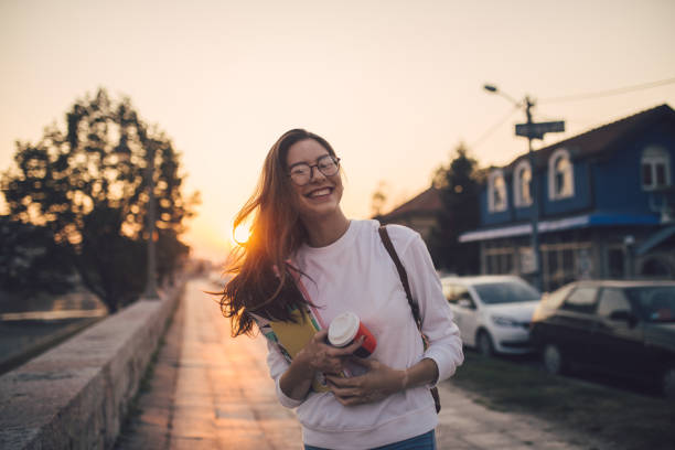 istock Smiling teenage student with textbooks and a coffee cup 1194523562