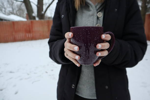 istock Woman holding hot chocolate 1194523919