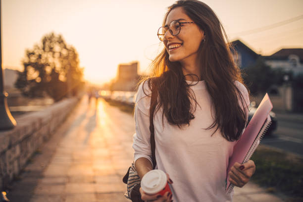 istock Smiling student girl going home from university 1194524142