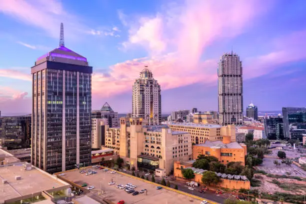 Sandton City centre with the Leonardo building, Michelangelo apartments, under a sunset cloudscape with Nelson Mandela Square,
Sandton has become home to most of the major financial, consulting and banking firms in South Africa.  Sandton houses approximately 300000 residents and 10 000 businesses, including investment banks, top businesses, financial consultants, the Johannesburg stock exchange and one of the biggest convention centres on the African continent, the Sandton Convention Centre.