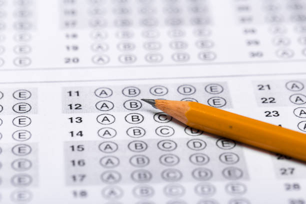 istock testing in exercise and exam paper. computer sheet with pencil in school test room, education concept 1194526043