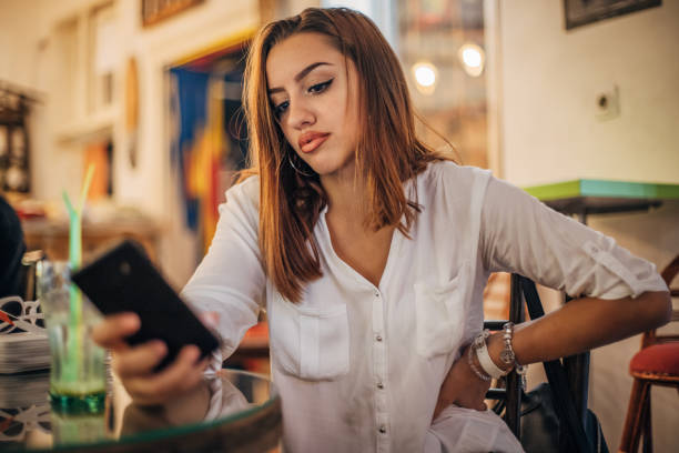 istock Young woman is using mobile phone 1194527131