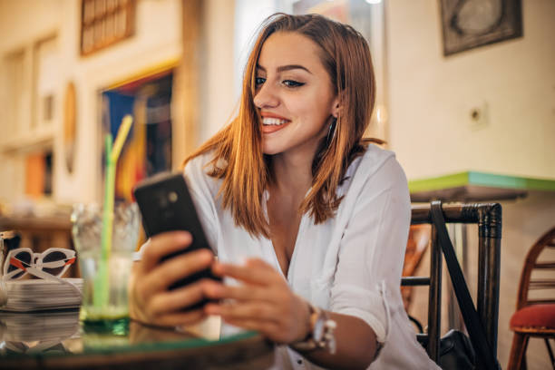 istock Cheerful young woman is taking selfie 1194528849
