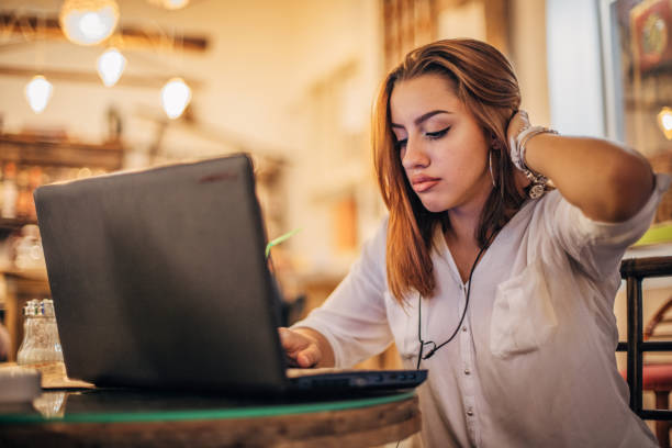 istock Young woman is using laptop at cafe 1194528914