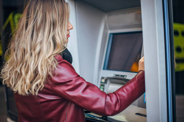 istock Woman is withdrawing money from ATM machine 1194530143