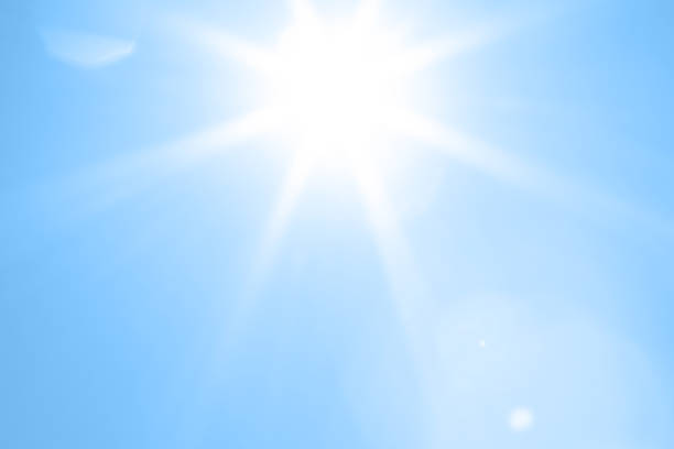 Bright sun with beautiful beams in the sky. Space for copy.
