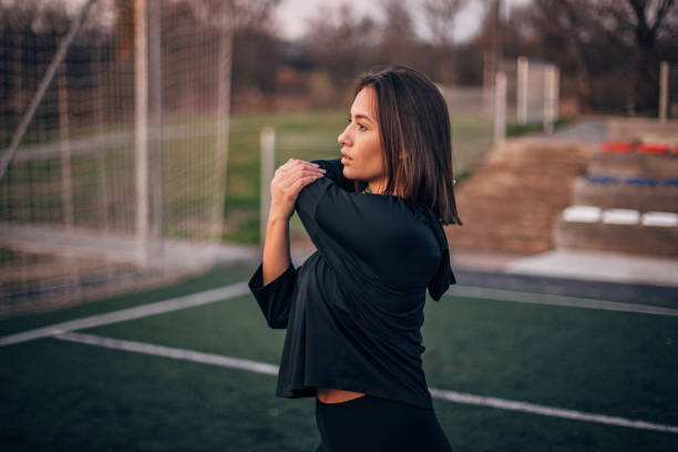 istock Young woman is stretching arms 1194532568