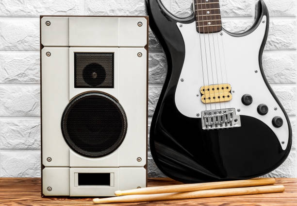 istock Guitar with audio speaker near wall. 1194532792
