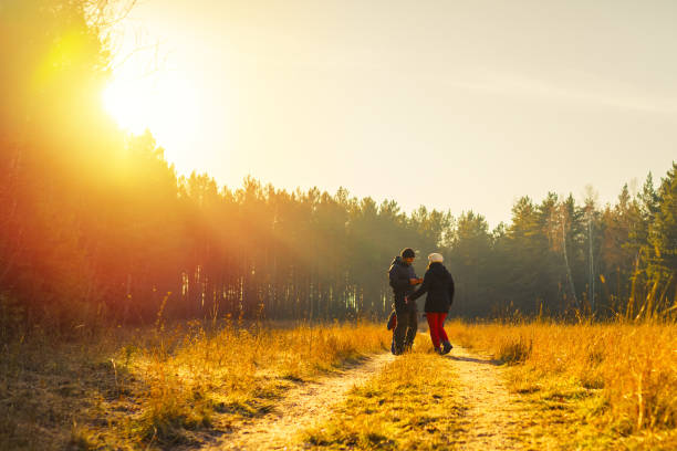 Couple walking together on promenade in golden sunlight