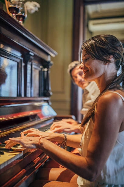 istock Couple playing piano together 1194534278