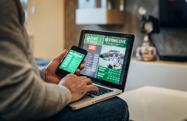 istock Man watches soccer game and bets 1194534406