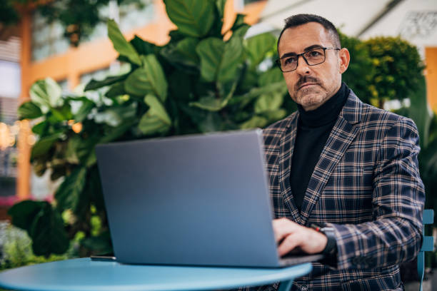 istock Mature elegant businessman is working on laptop 1194535315