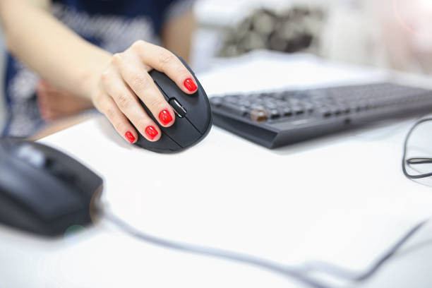 istock girl's hand uses a vertical ergonomic computer mouse joystick. 1194536717